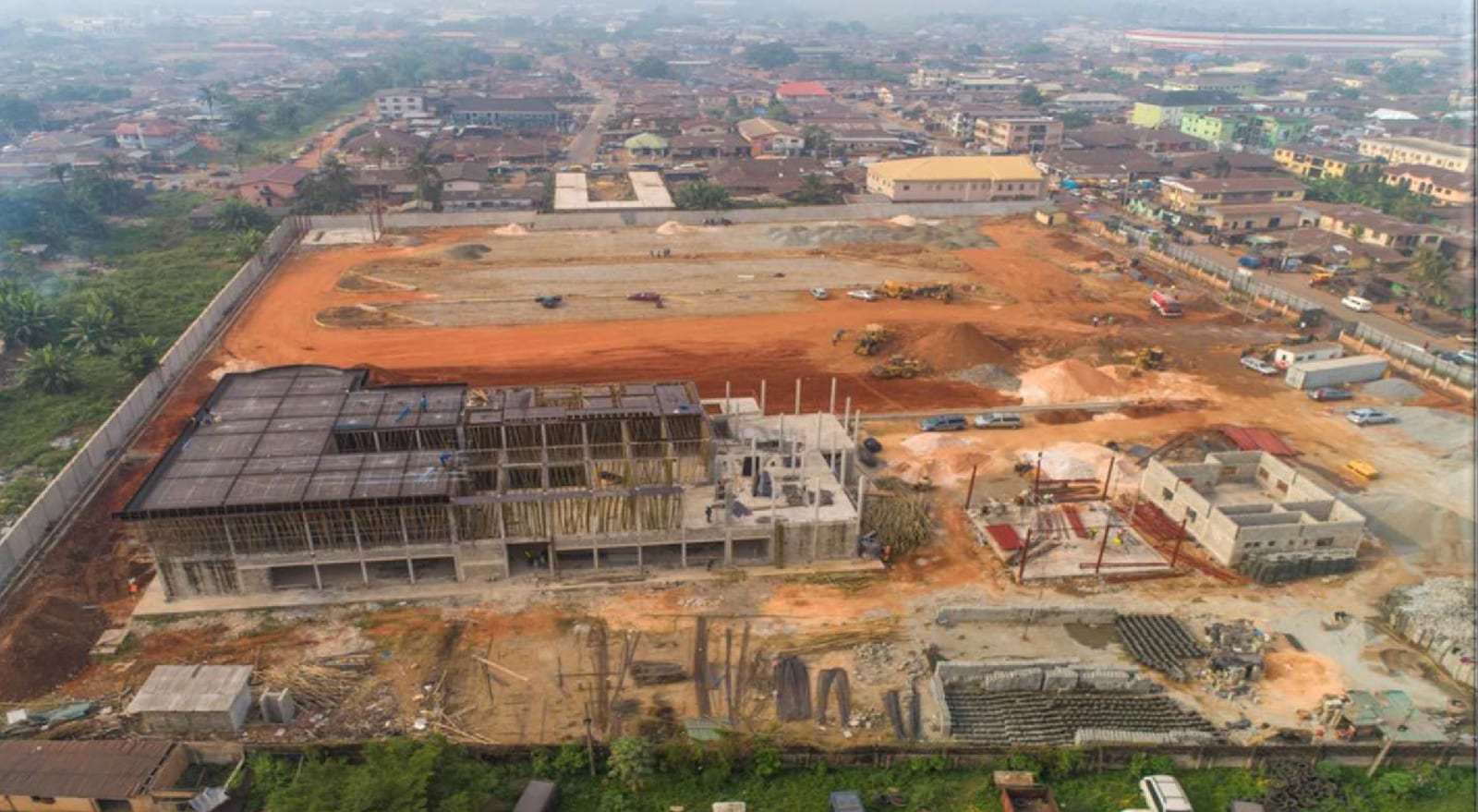 Aerial view of the terminal building taking shape on a graded site during construction