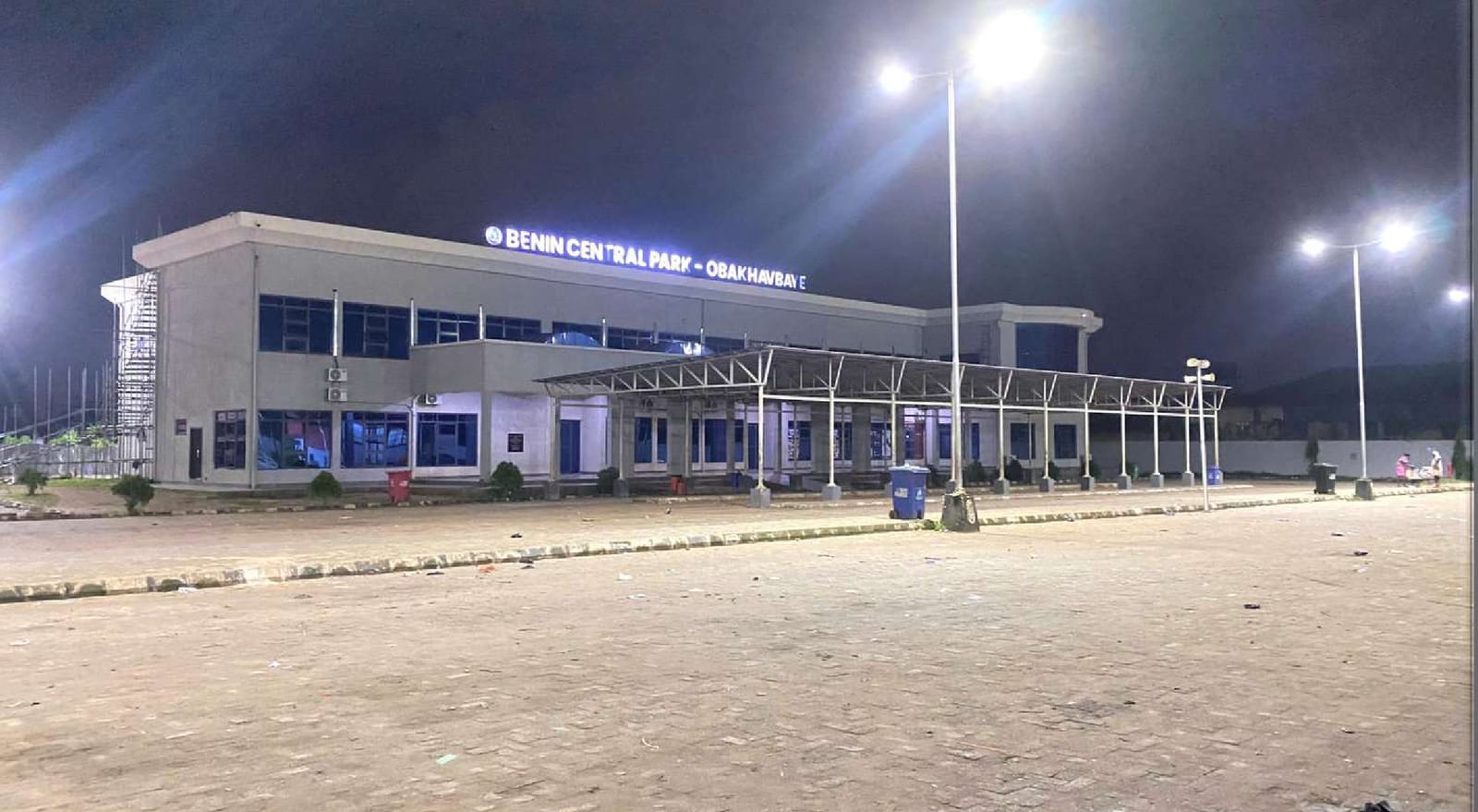 Benin Central Park terminal lit up at night under floodlight poles