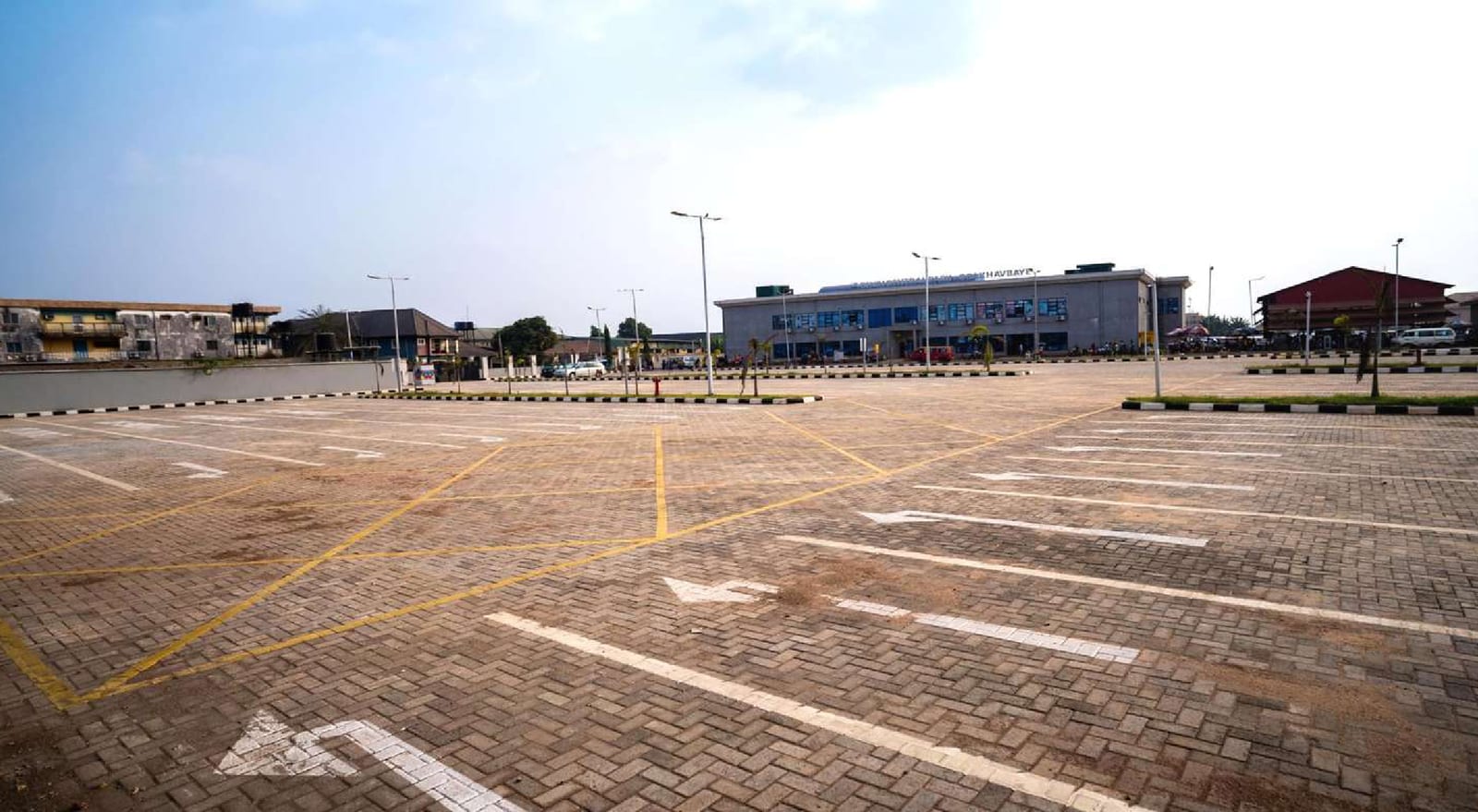 Interlock-paved parking area with painted bay markings at the bus terminal