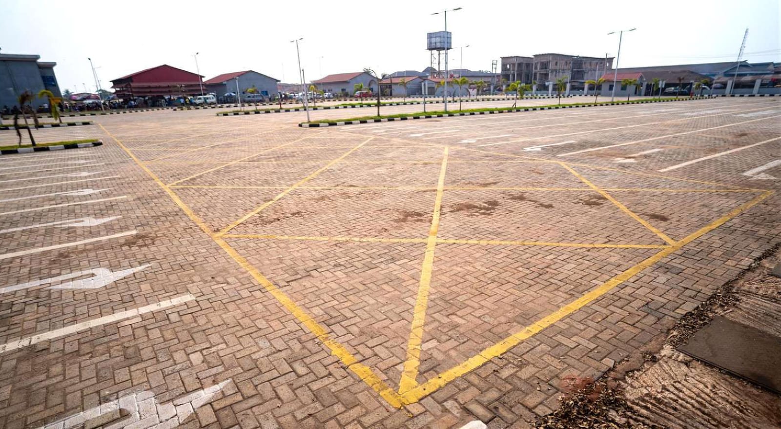 Paved vehicle manoeuvring area with yellow road markings at the bus terminal