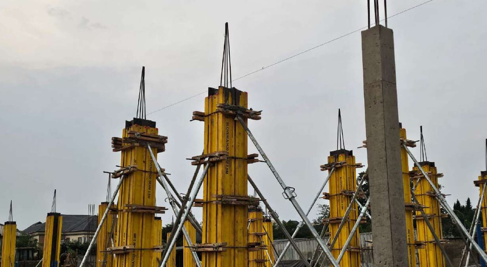 Yellow column formwork and starter bars for the concrete frame of the Fidelity Bank building