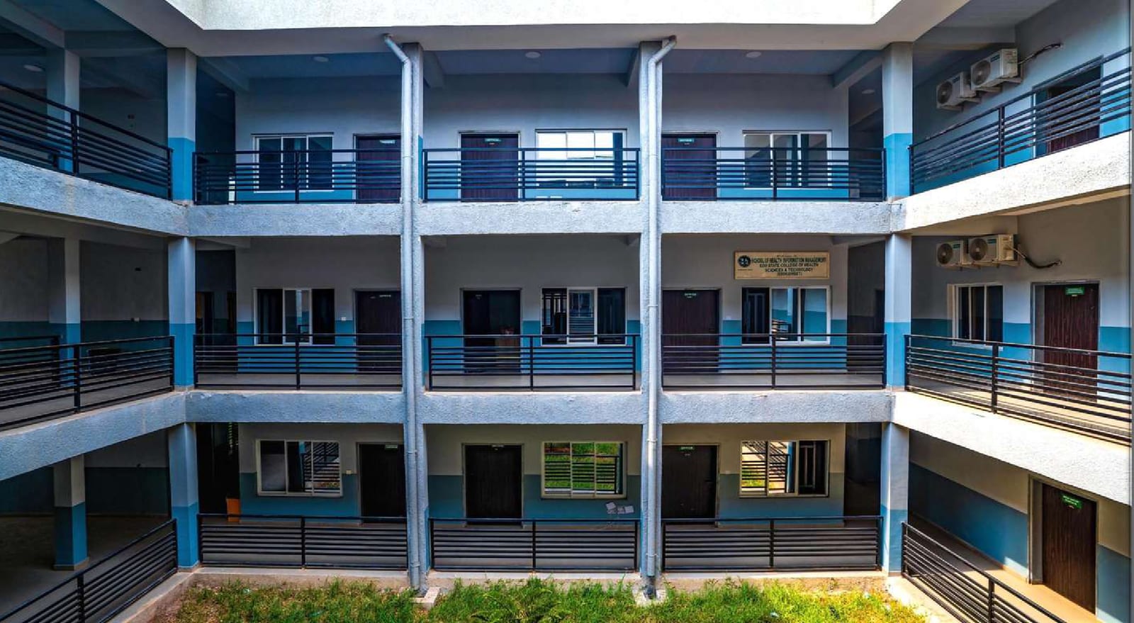 Three-storey courtyard elevation with balcony walkways and metal railings