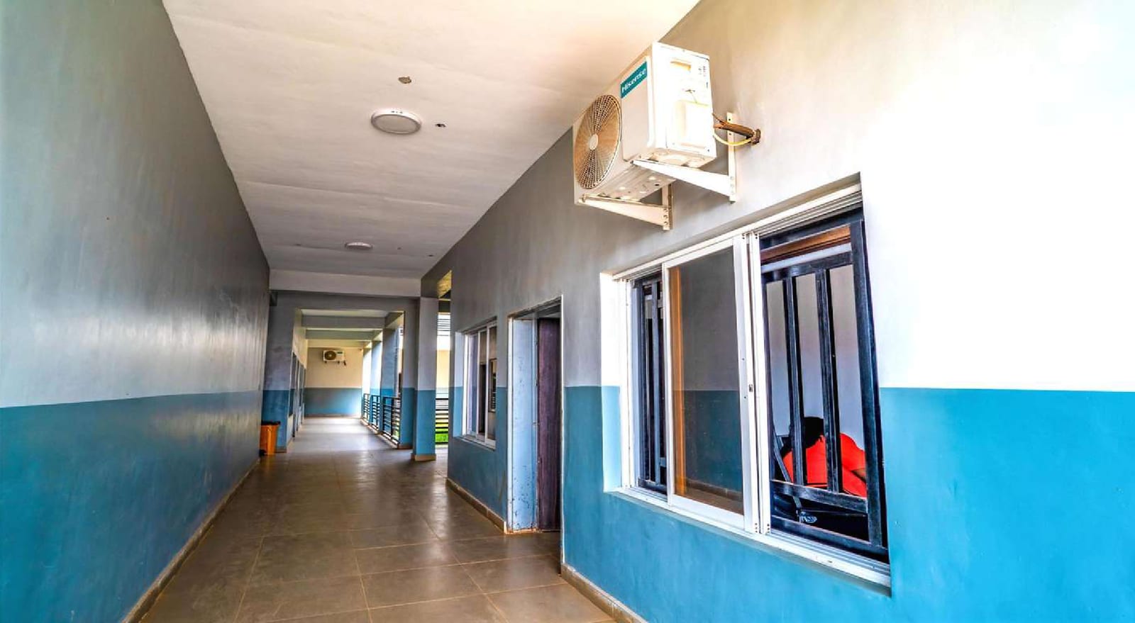 Corridor inside the academic building with blue and white walls and air conditioning