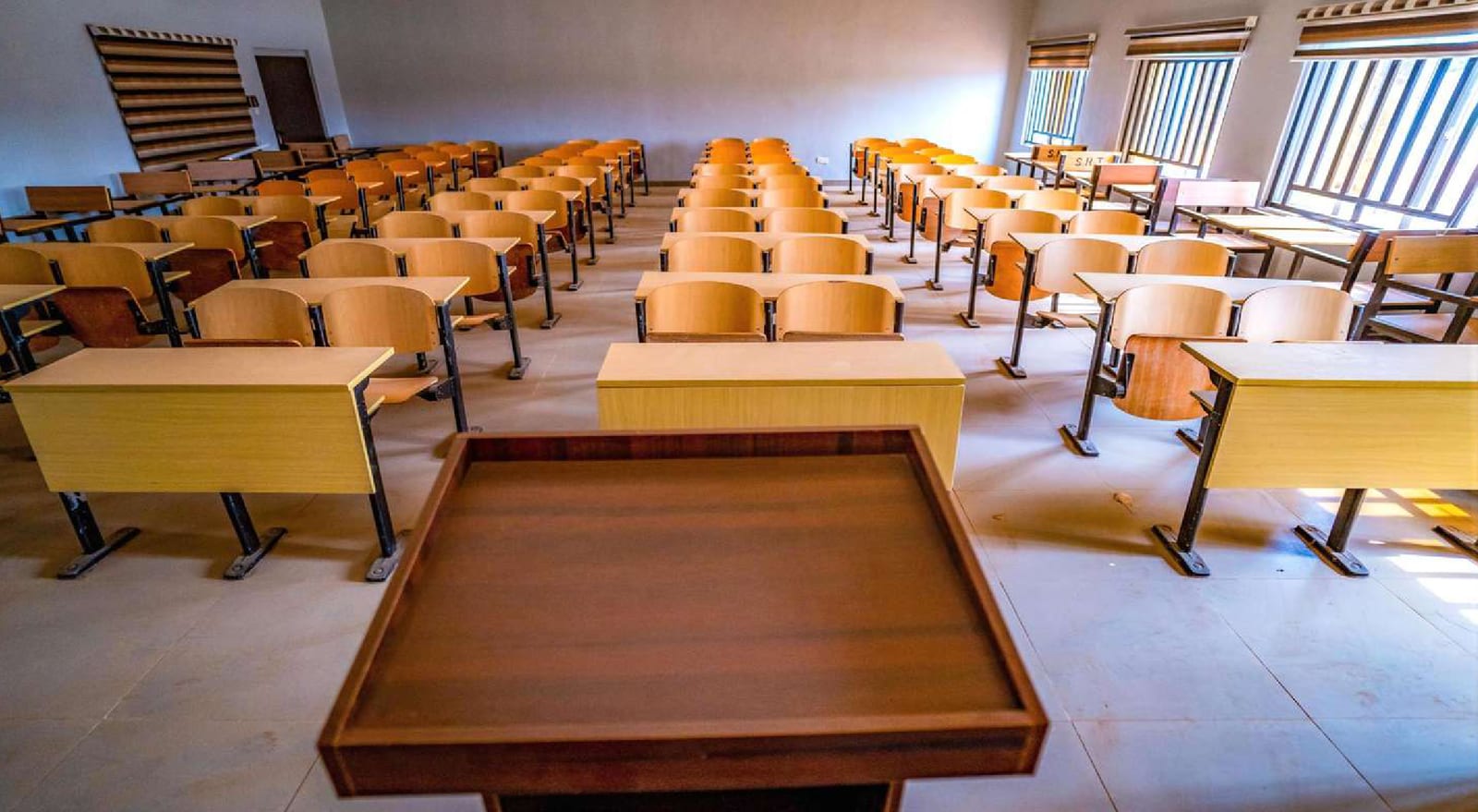 Lecture hall with tiered desks and a lectern in the new academic building