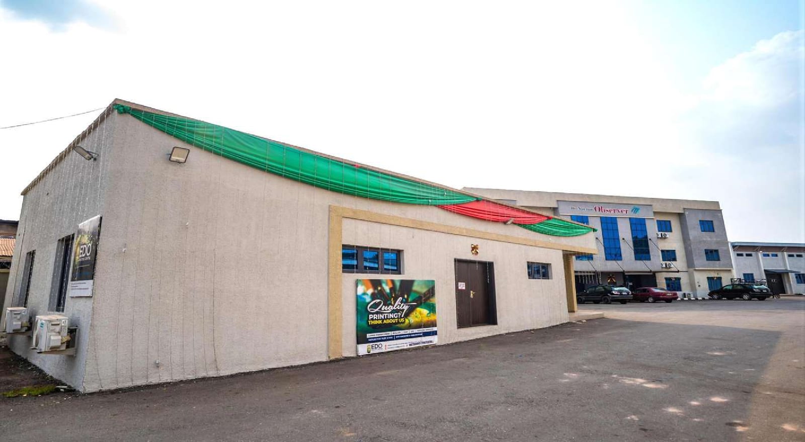 Printing house at the Nigerian Observer complex with a green and white ribbon on the roof edge