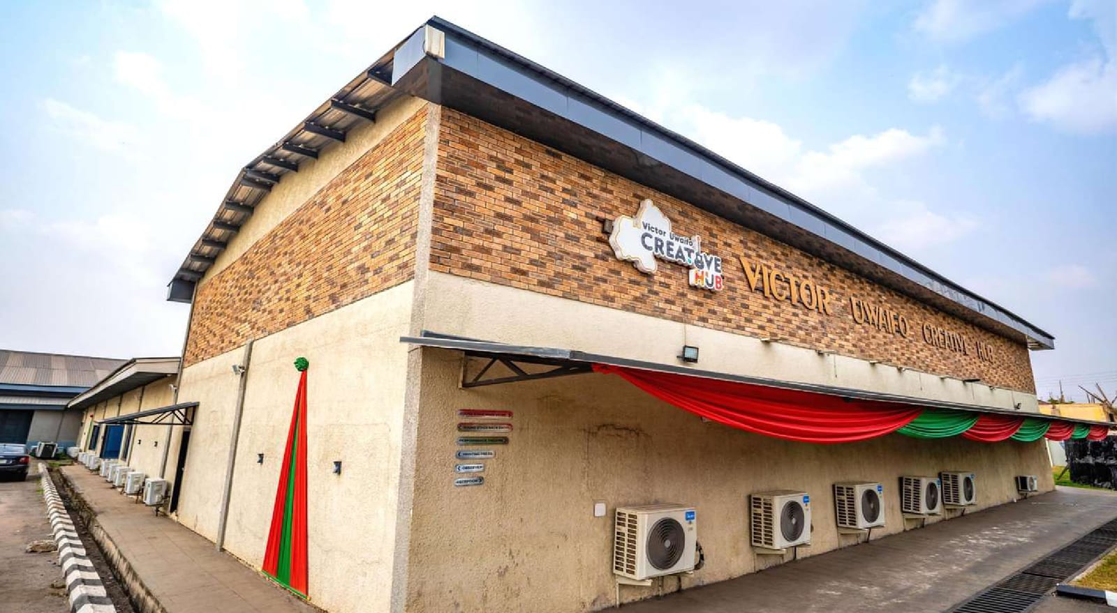 Renovated Edo Creative Hub building with stone-effect cladding and hub signage